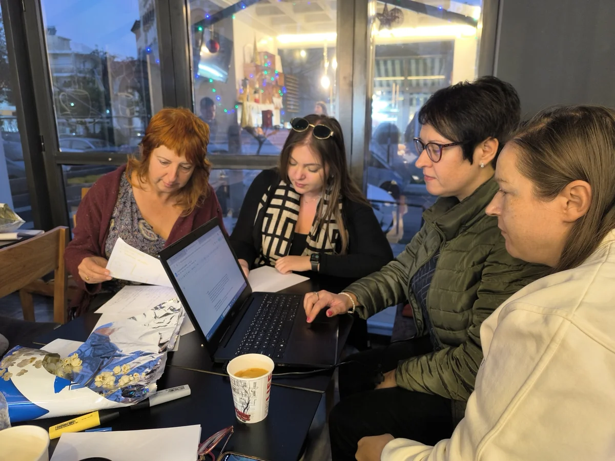 Participants working together around a laptop